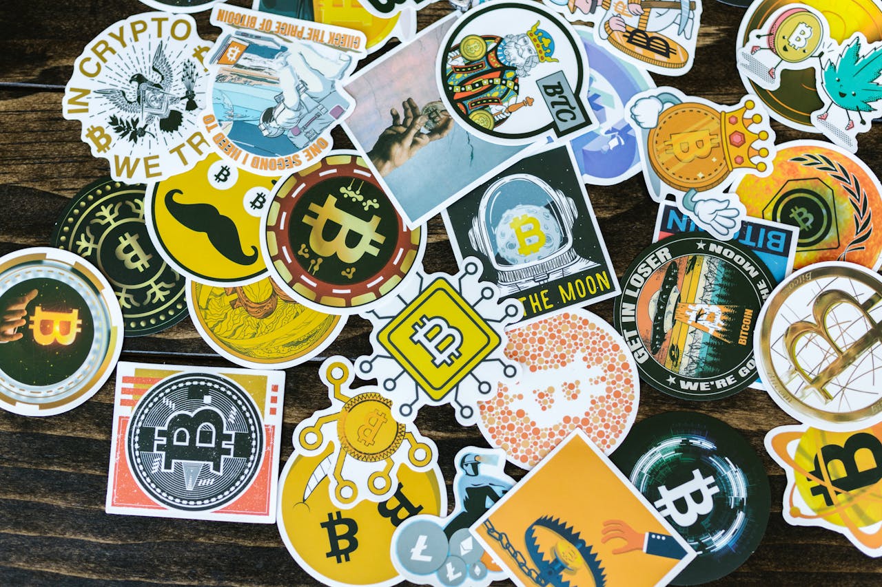 about-us Colorful collection of Bitcoin-themed stickers on a wooden background, ideal for cryptocurrency concepts.